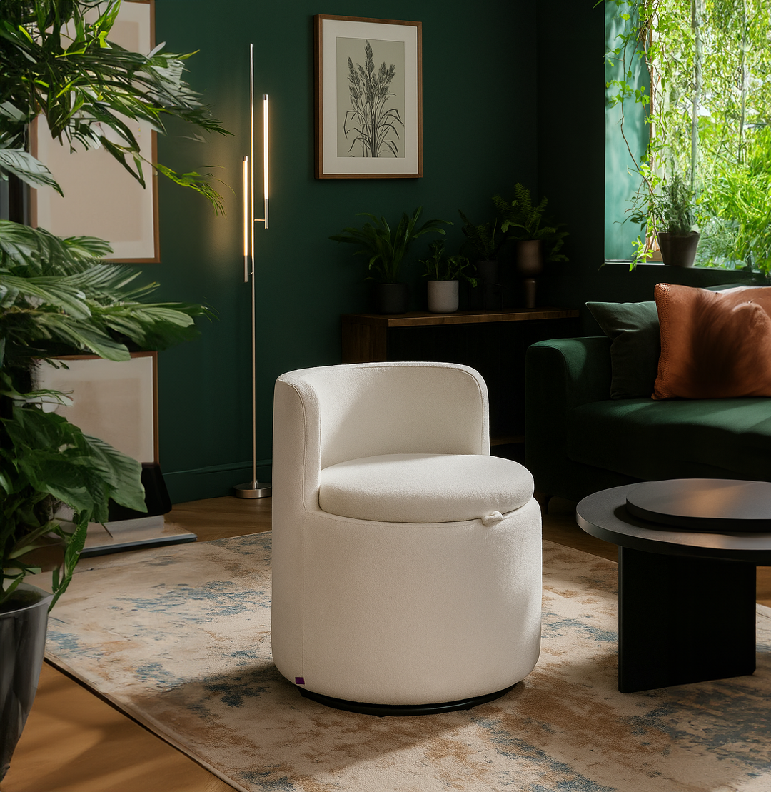 Modern living room with a white chair, green walls, and decorative plants.